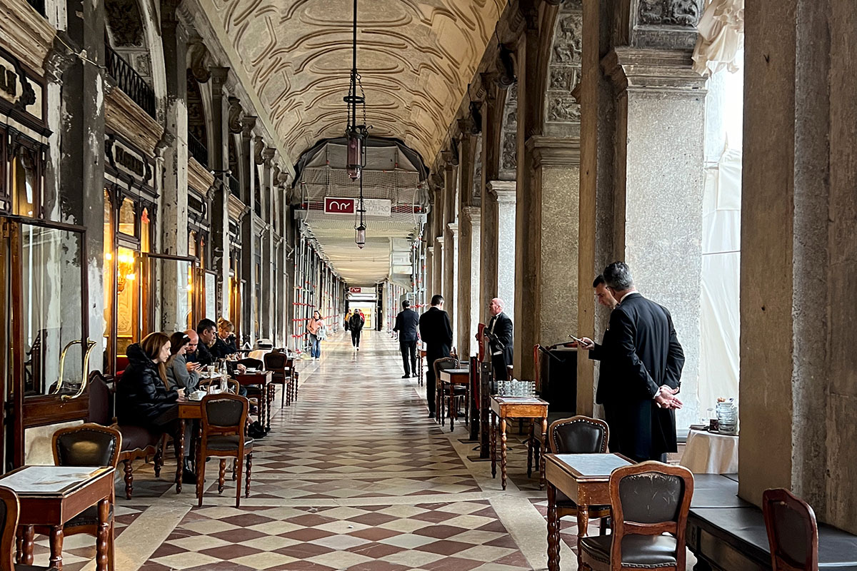 Looking down the Arcade in Venice past a cafe